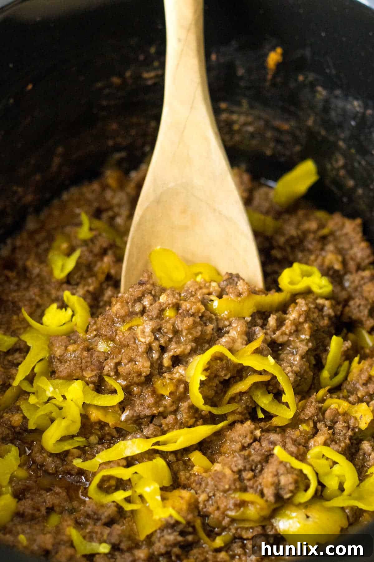 Hearty Slow Cooker Mississippi Sloppy Joes 2 A slow cooker filled with savory Mississippi Sloppy Joes mixture, ready to be served on buns.