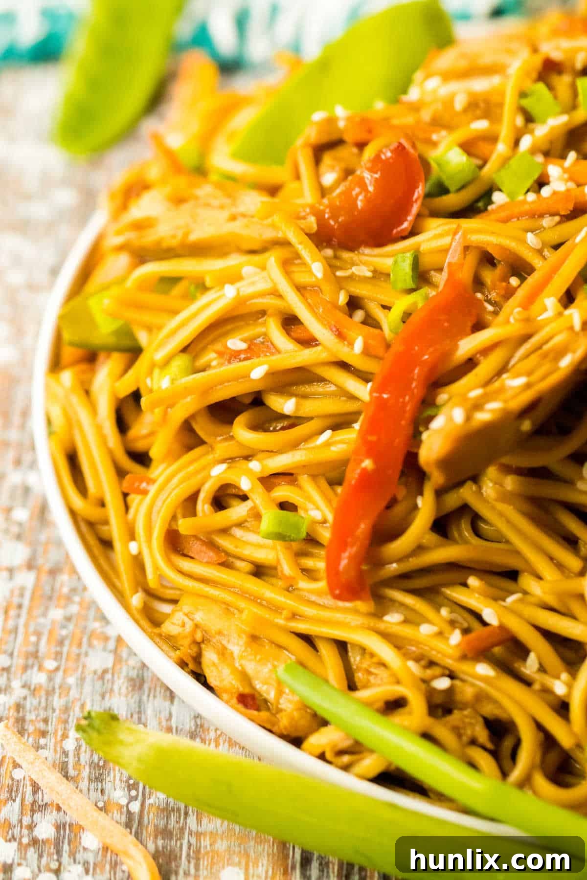 A close-up shot of a full plate of slow cooker chicken lo mein.