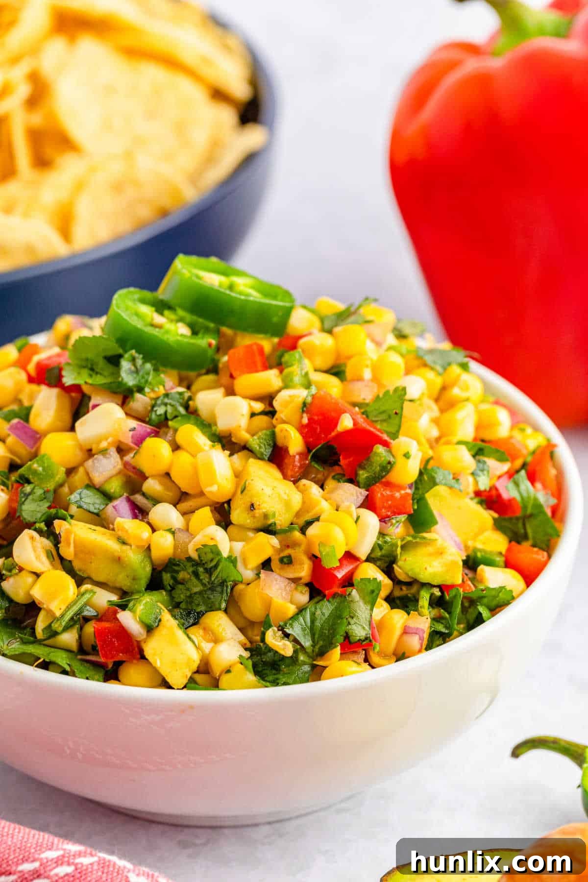 Zesty Corn Salsa 6 A top-down view of corn salsa, showing colorful ingredients mixed.