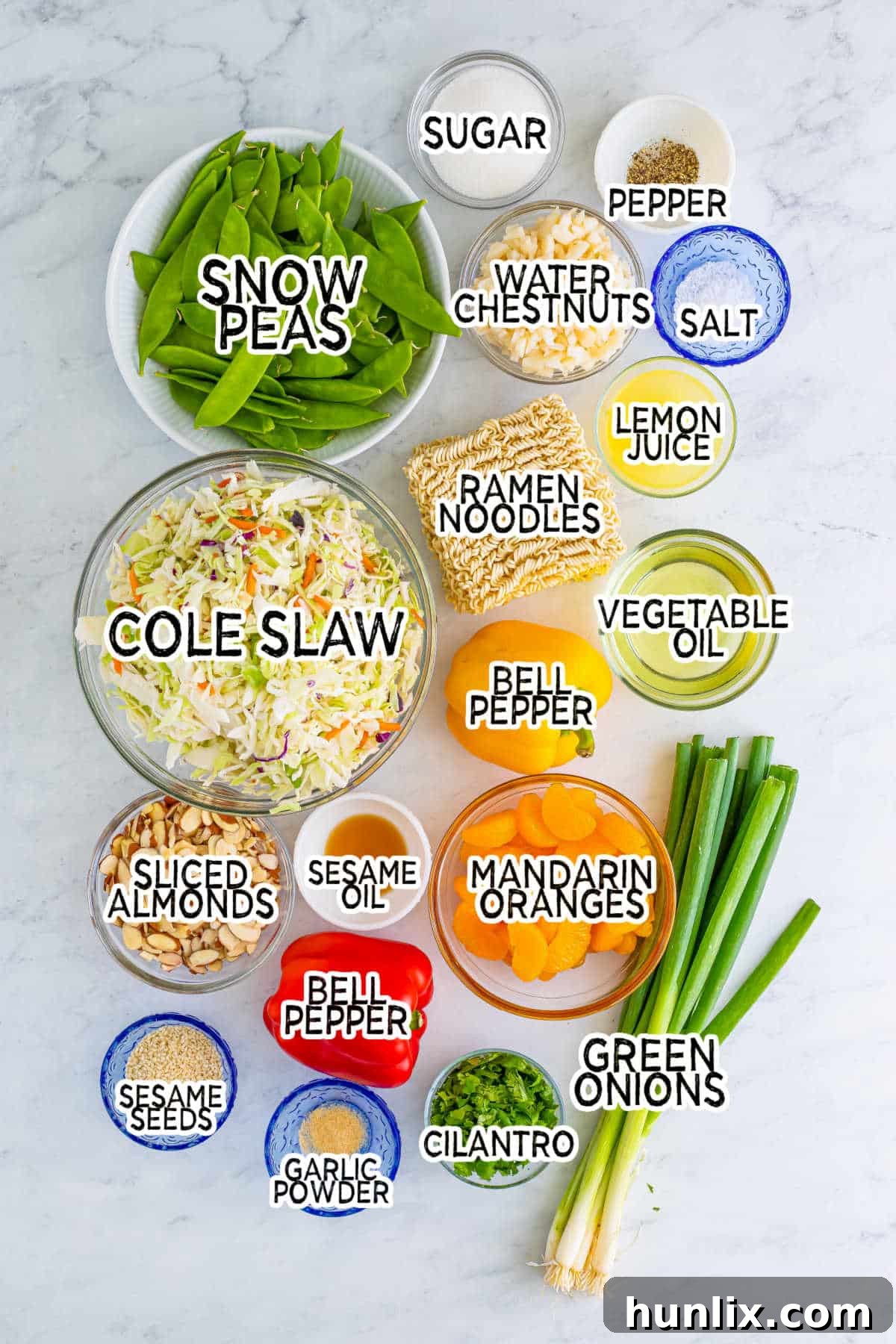 A collection of fresh ingredients laid out for making ramen noodle salad.