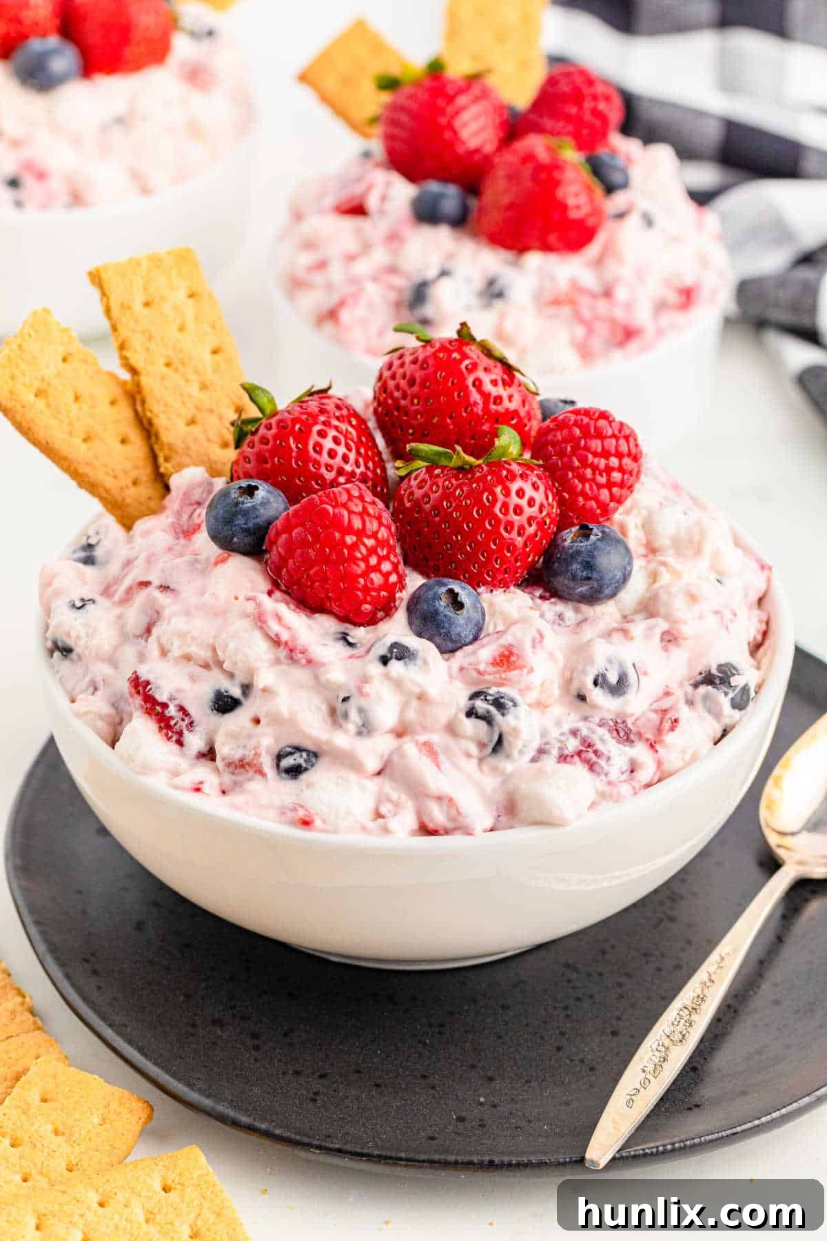 A large bowl of Berry Cheesecake Fluff with graham cracker pieces embedded, suggesting it can be served as a dip.