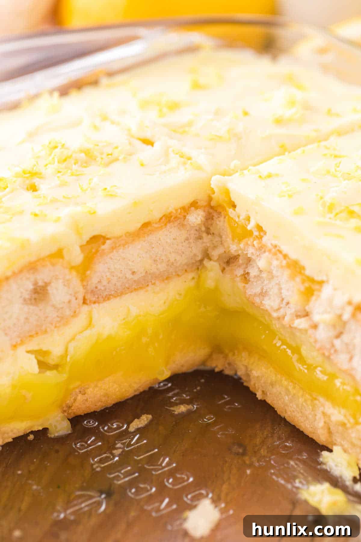 Italian Lemon Cloud 2 A perfectly sliced Lemon Tiramisu in a glass pan, showcasing its beautiful layers.