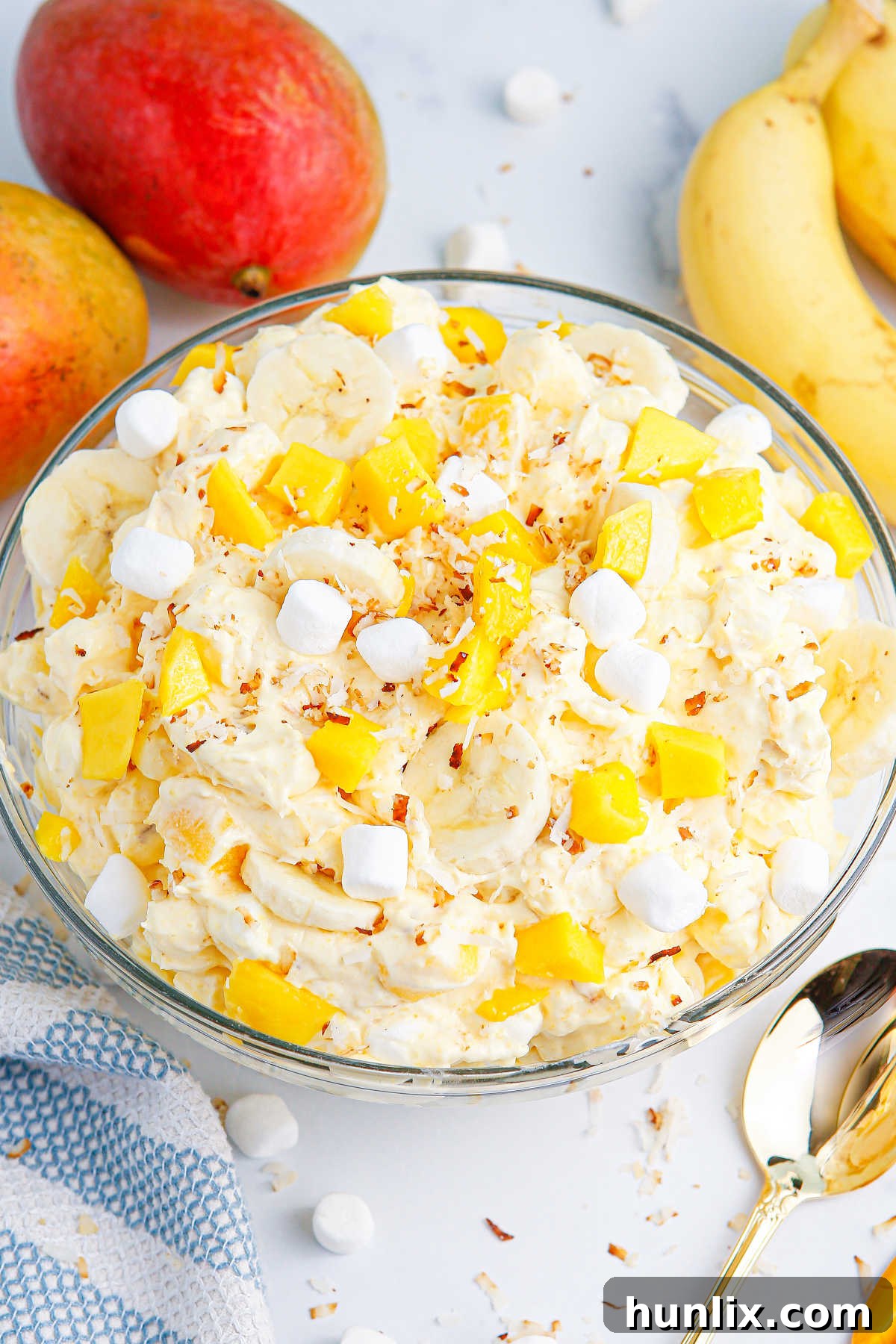 Tropical Mango Banana Fluff 2 A vibrant bowl of creamy Mango Banana Marshmallow Salad, ready to be served at a summer gathering.
