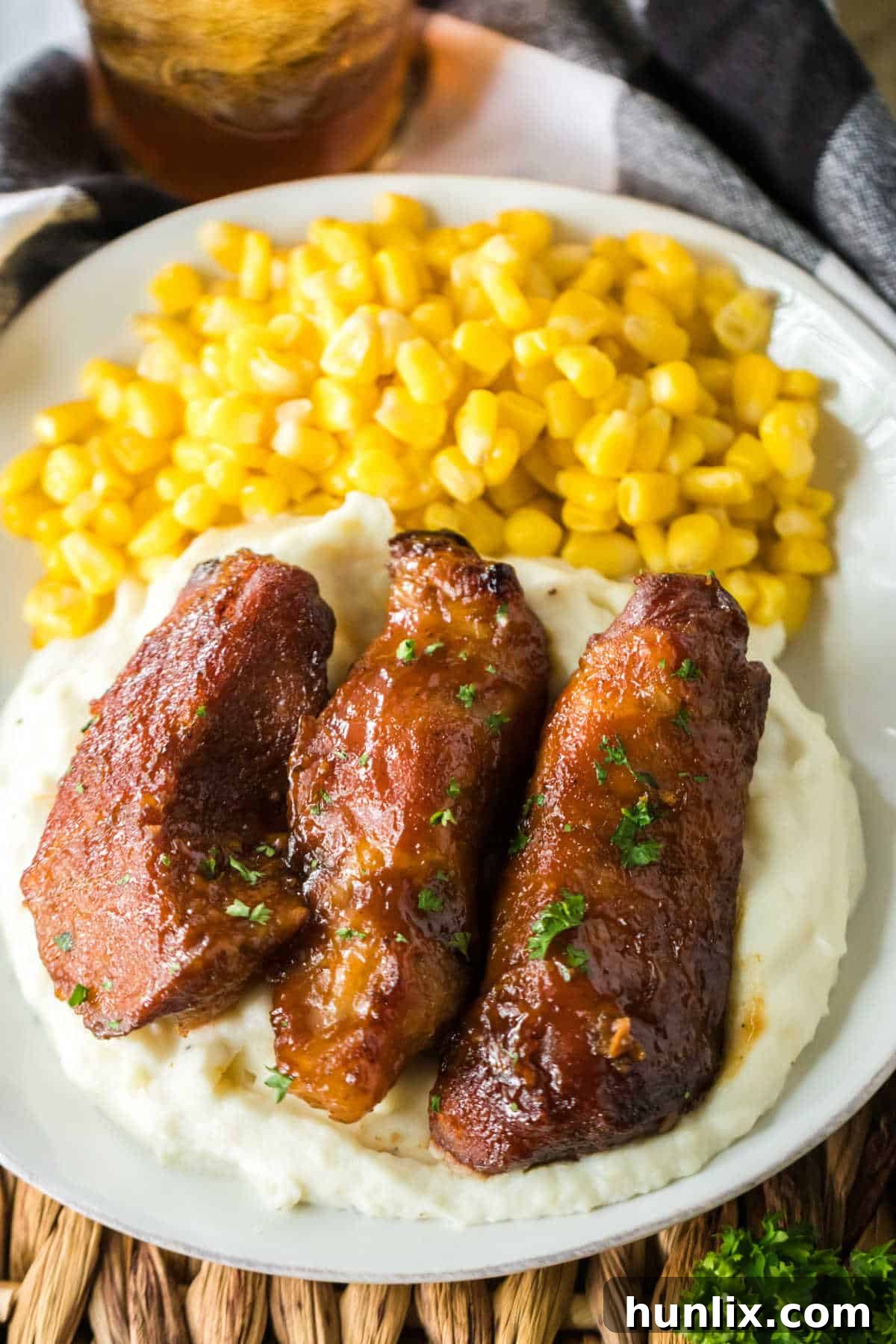 Melt-in-Your-Mouth Slow Cooker Country Ribs 6 A plate with slow cooker country style ribs, mashed potatoes, and corn.