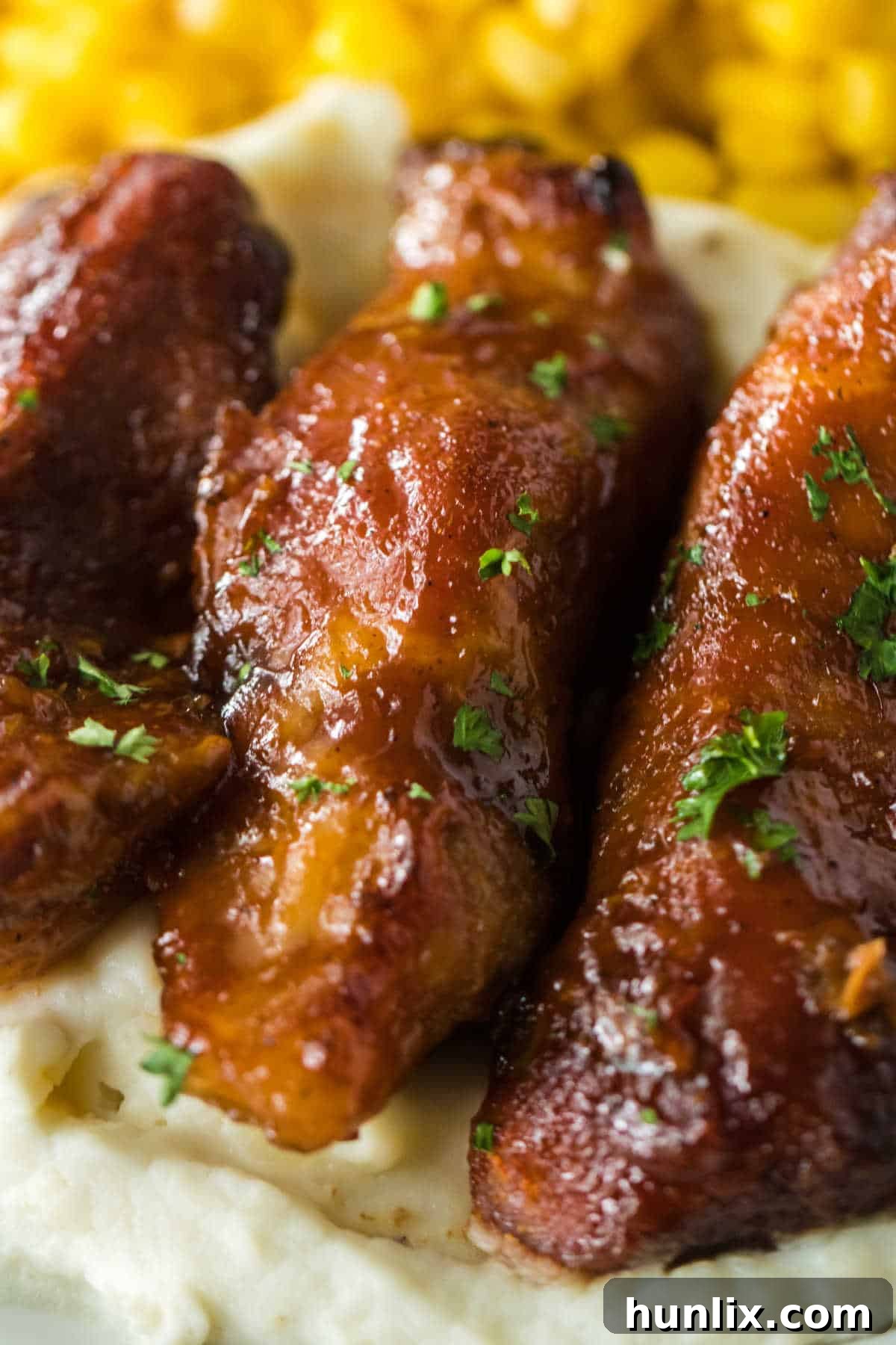 Melt-in-Your-Mouth Slow Cooker Country Ribs 7 Close-up of country-style ribs served on a bed of mashed potatoes.