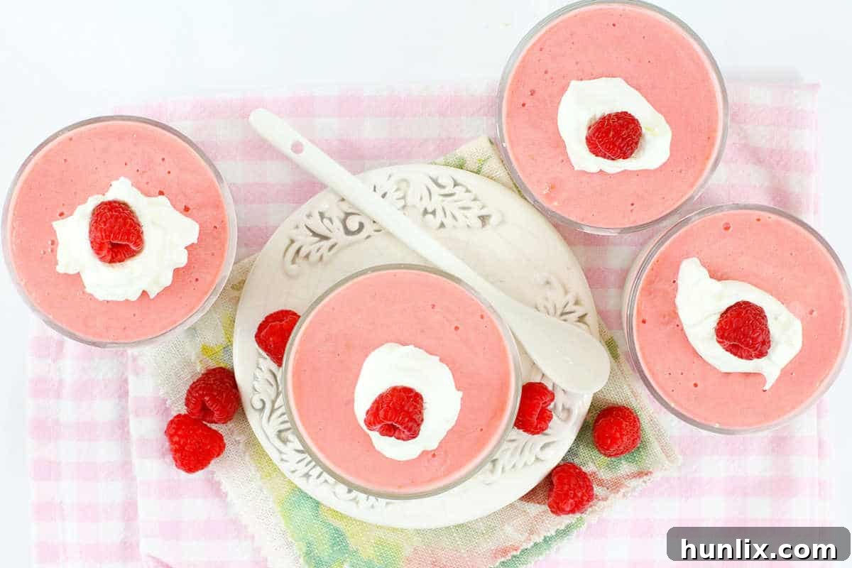 A group of beautifully arranged raspberry cheesecake cups, ready to serve.