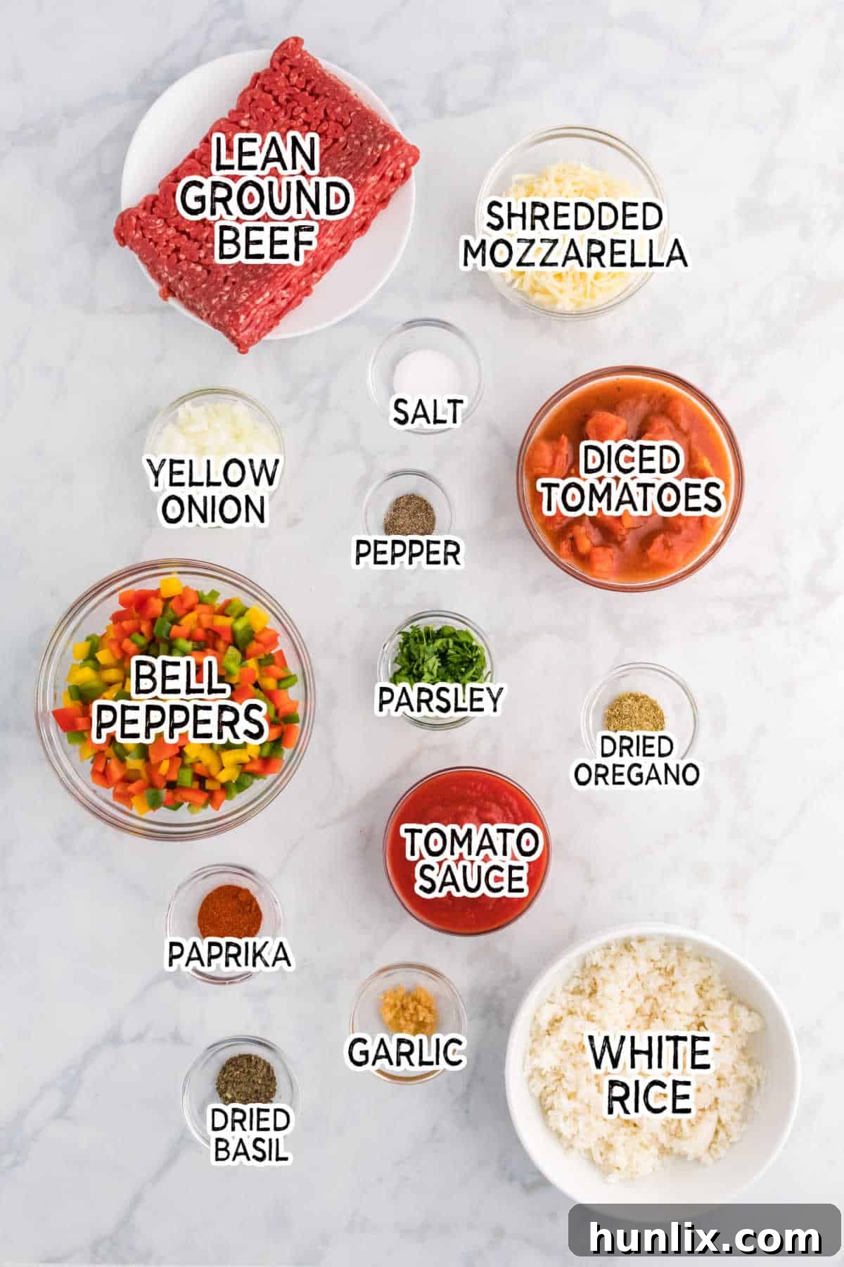 Various ingredients laid out for stuffed pepper casserole preparation.
