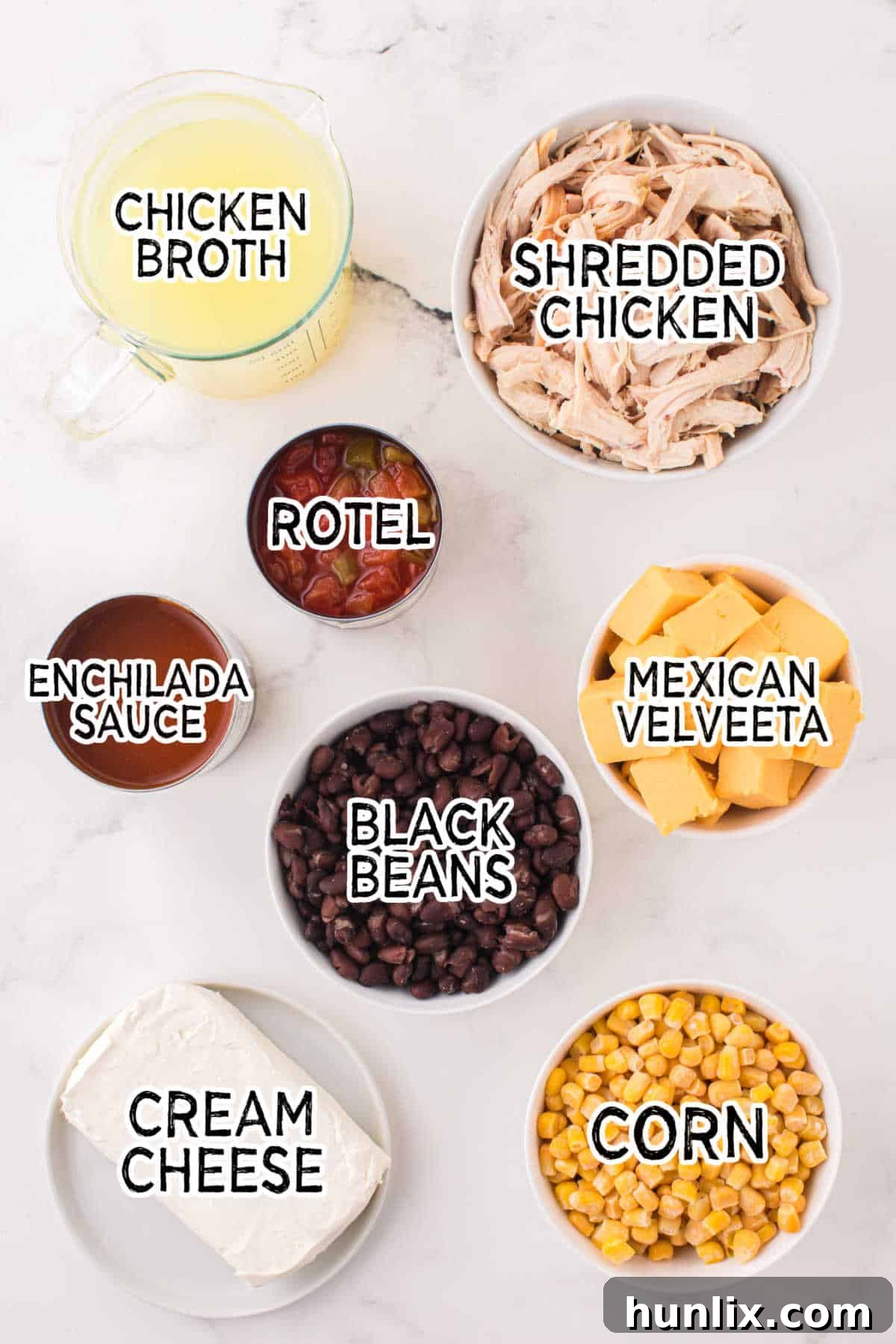 A flat lay image displaying all the key ingredients neatly arranged to make homemade Chicken Enchilada Soup.