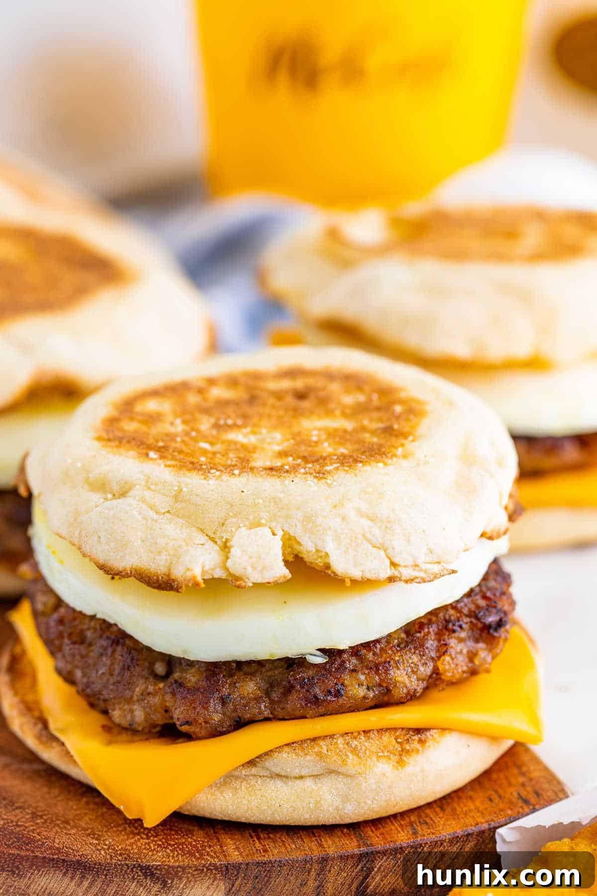 A copycat McDonad's Sausage Egg McMuffins on a wooden surface.