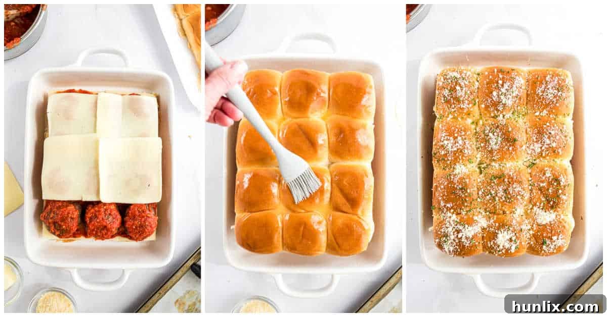 Baked meatball sliders in a pan, topped with melted cheese and herbs.