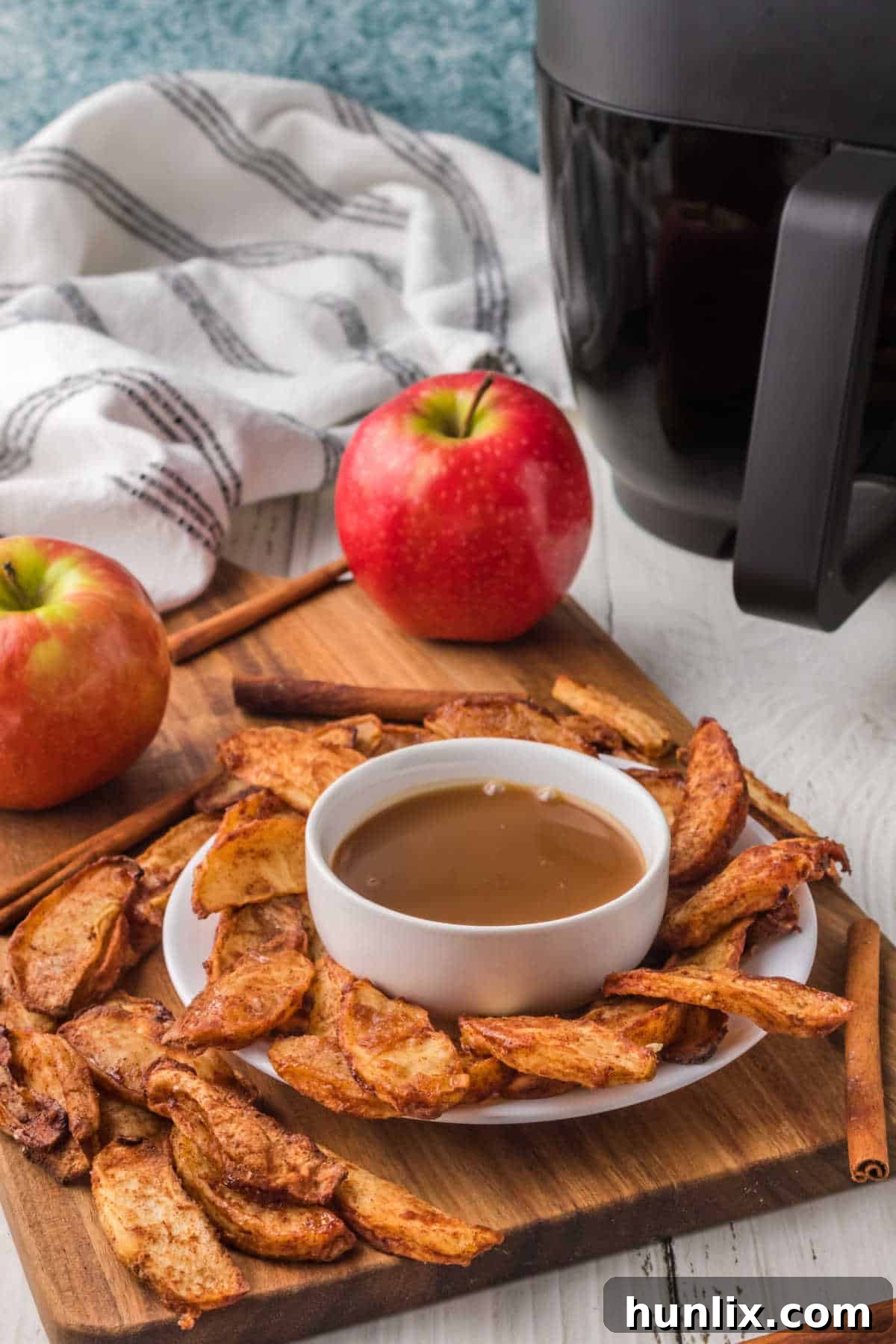 The recipe on a platter with a bowl of caramel, ready to serve.