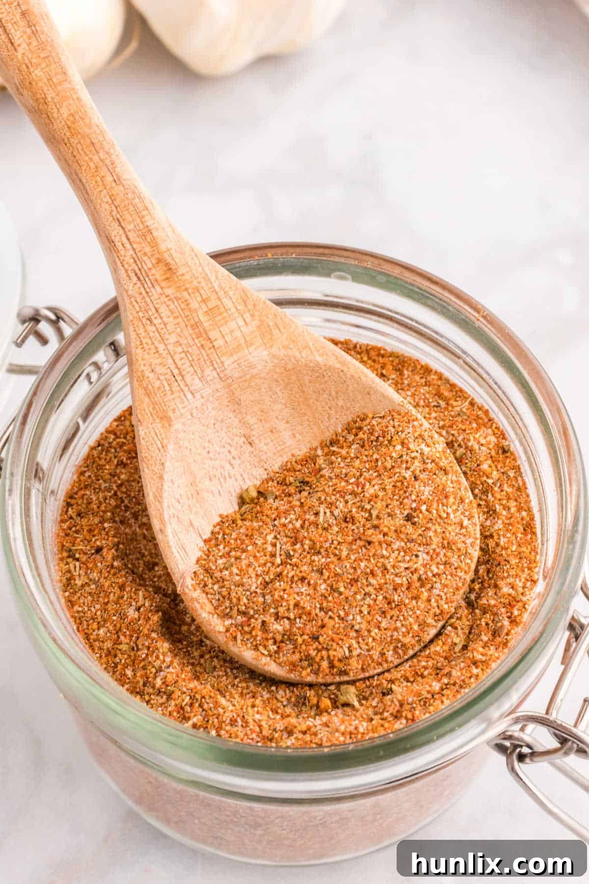 Louisiana Soul Spice 2 Cajun seasoning in a canister with a wooden spoon.