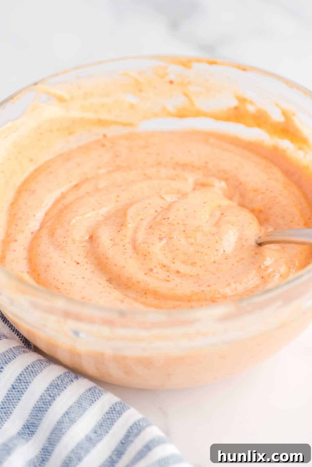 Yum Yum Sauce in a bowl with a spoon, ready to be served.
