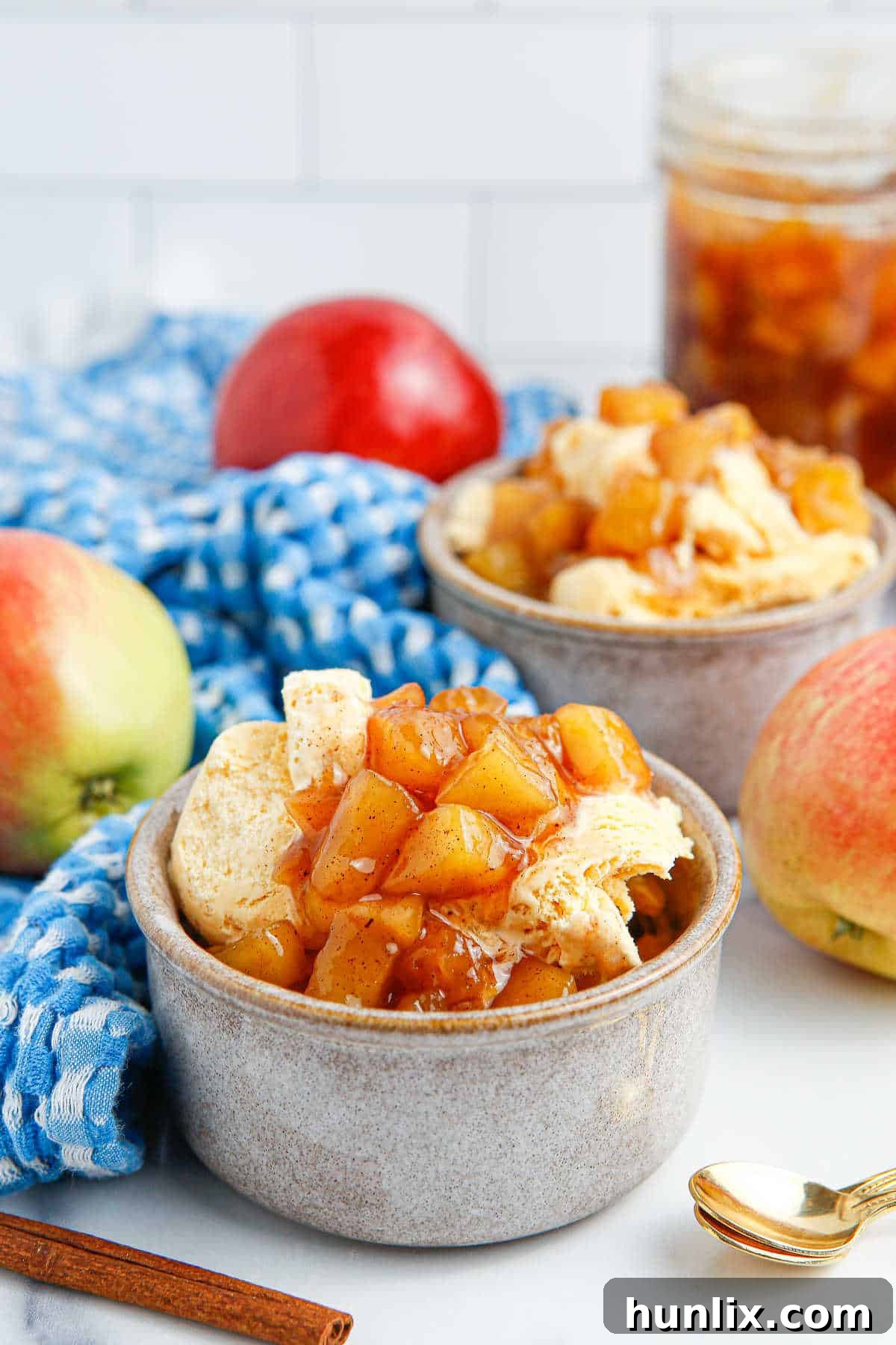 A lovely bowl of vanilla ice cream generously topped with homemade apple compote, ready to be enjoyed.