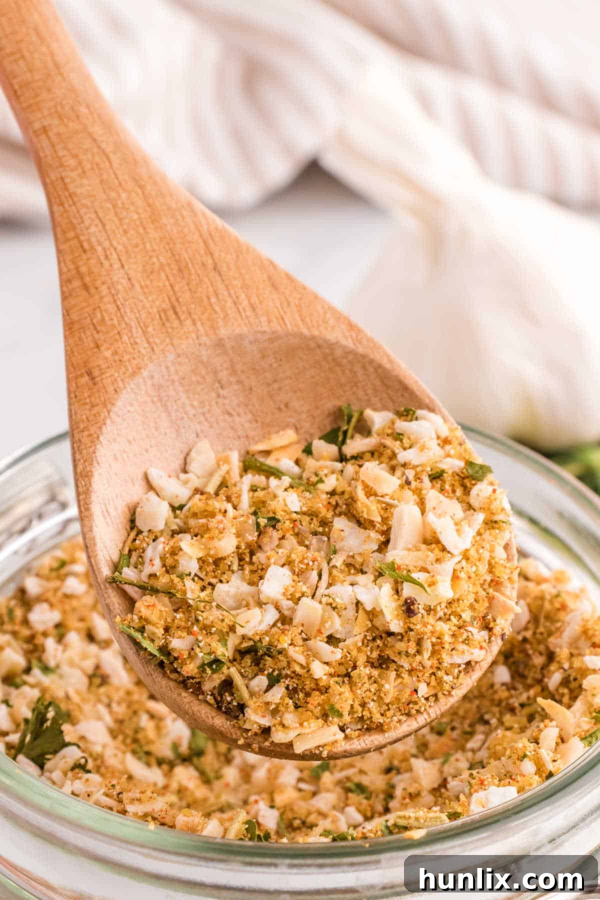 Aromatic Onion Seasoning 2 Onion soup mix on a wooden spoon, showcasing its rustic, homemade appeal.