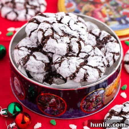 Freshly baked Chocolate Crinkle Cookies dusted with powdered sugar, a perfect holiday treat.