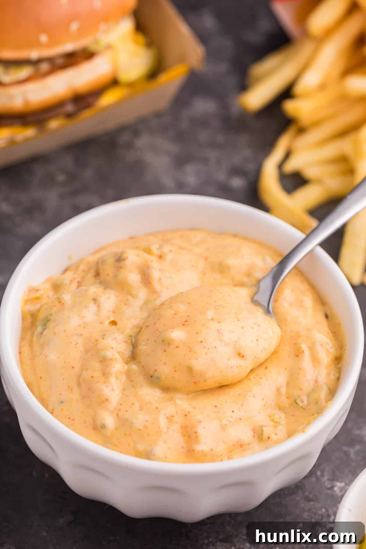 Big mac sauce in a bowl with a spoon.