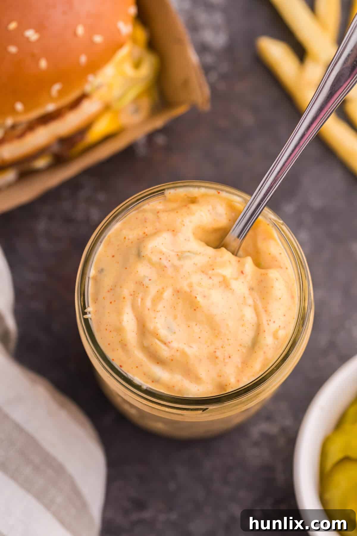 Big mac sauce in a jar with a spoon.