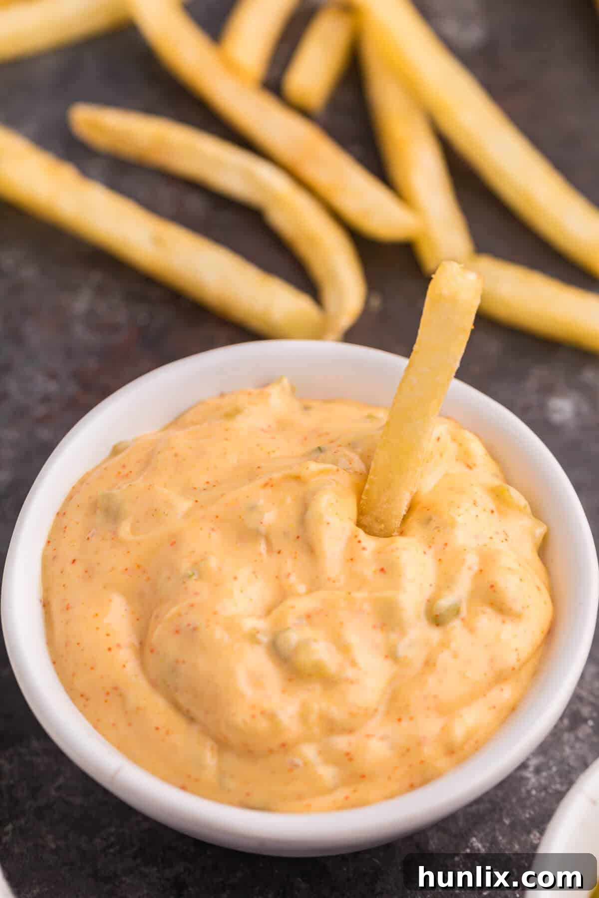 Big mac sauce in a bowl with a French fry in it.