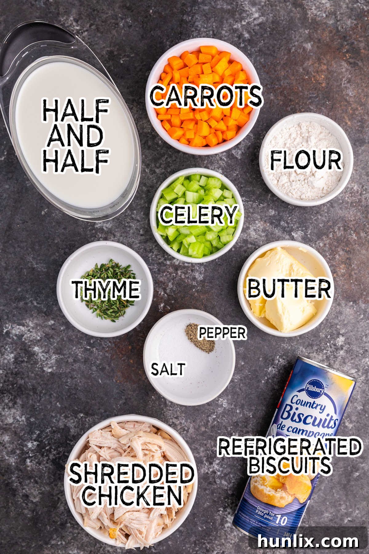 A selection of fresh ingredients laid out, including chicken, vegetables, butter, and herbs, ready for making cast iron skillet chicken pot pie.
