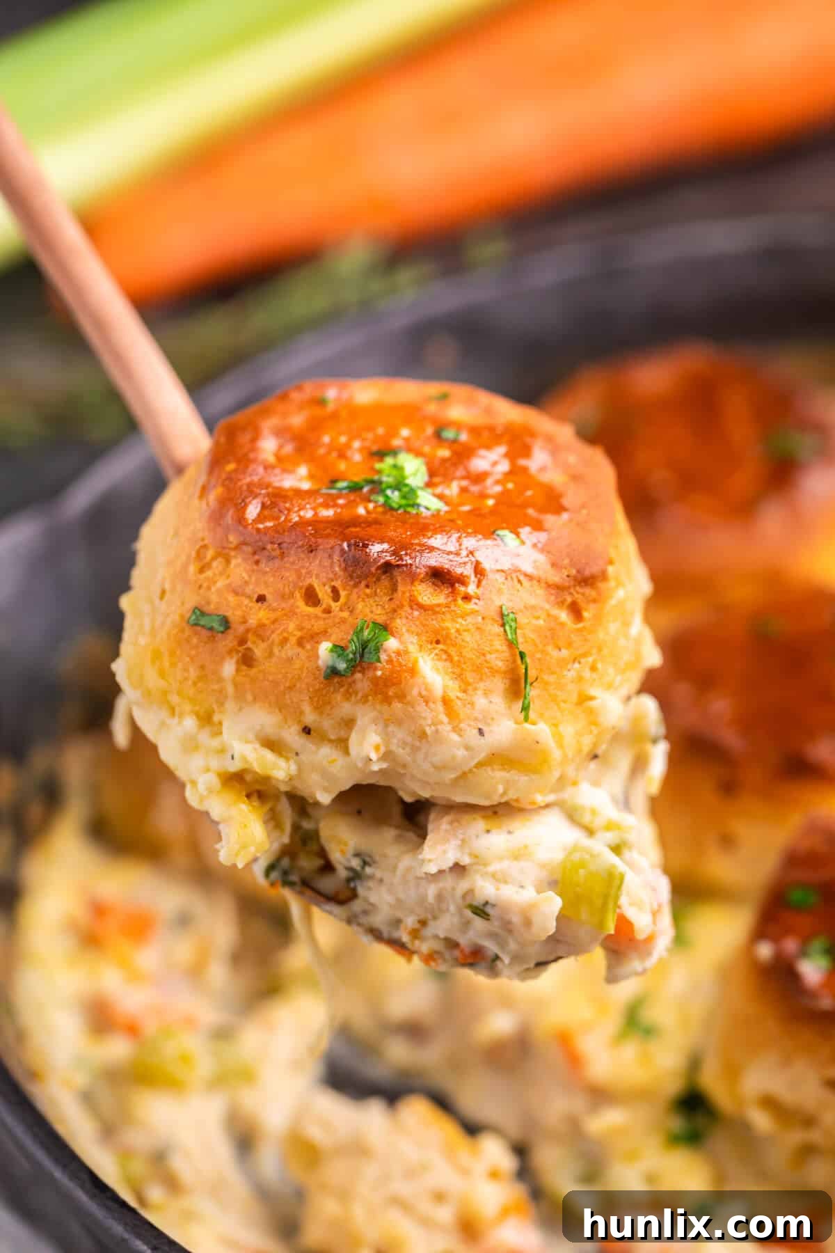 A serving of cast iron skillet chicken pot pie on a spoon, ready to be eaten.