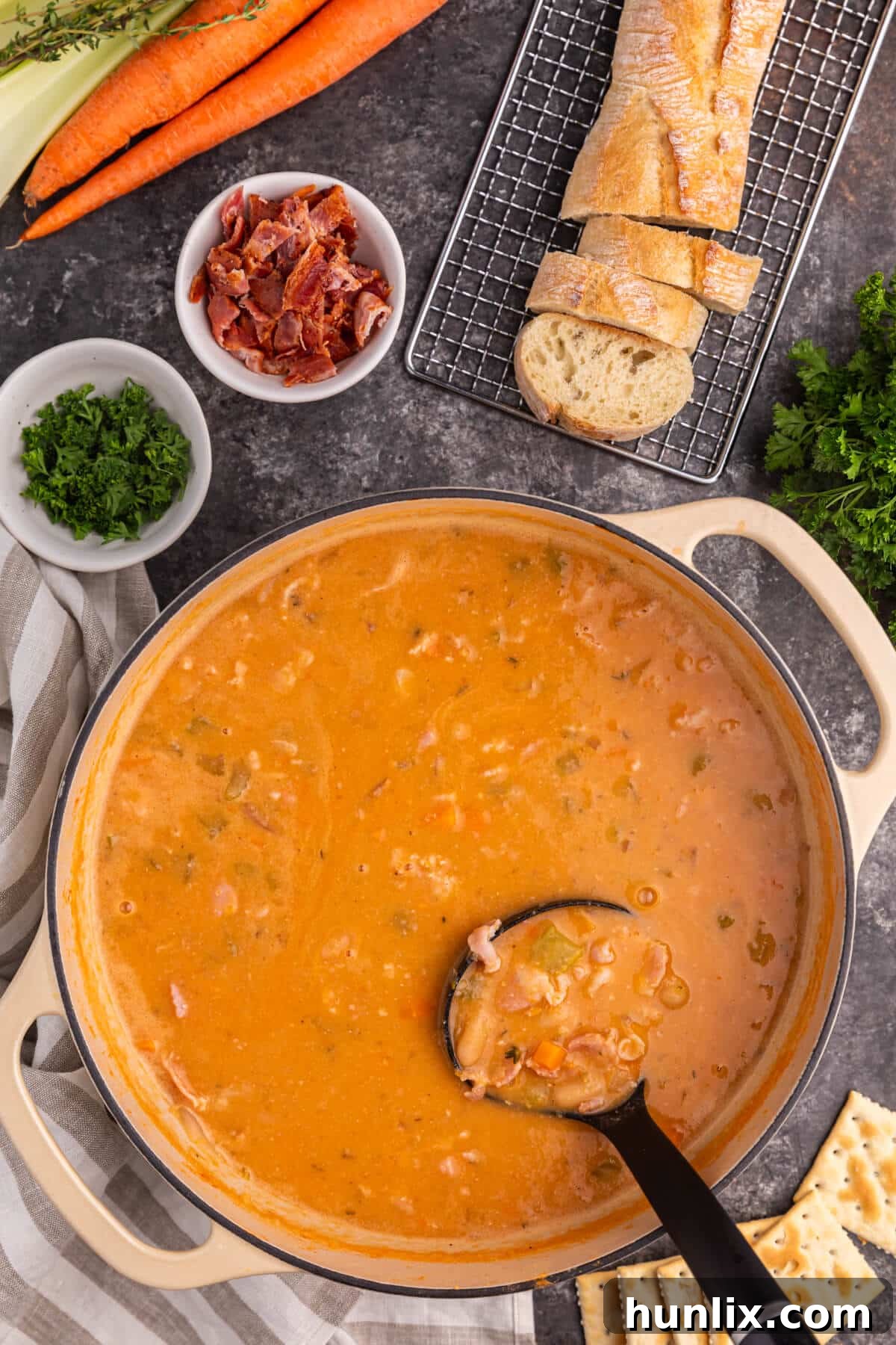 Bean with bacon soup in a pot with a ladle.