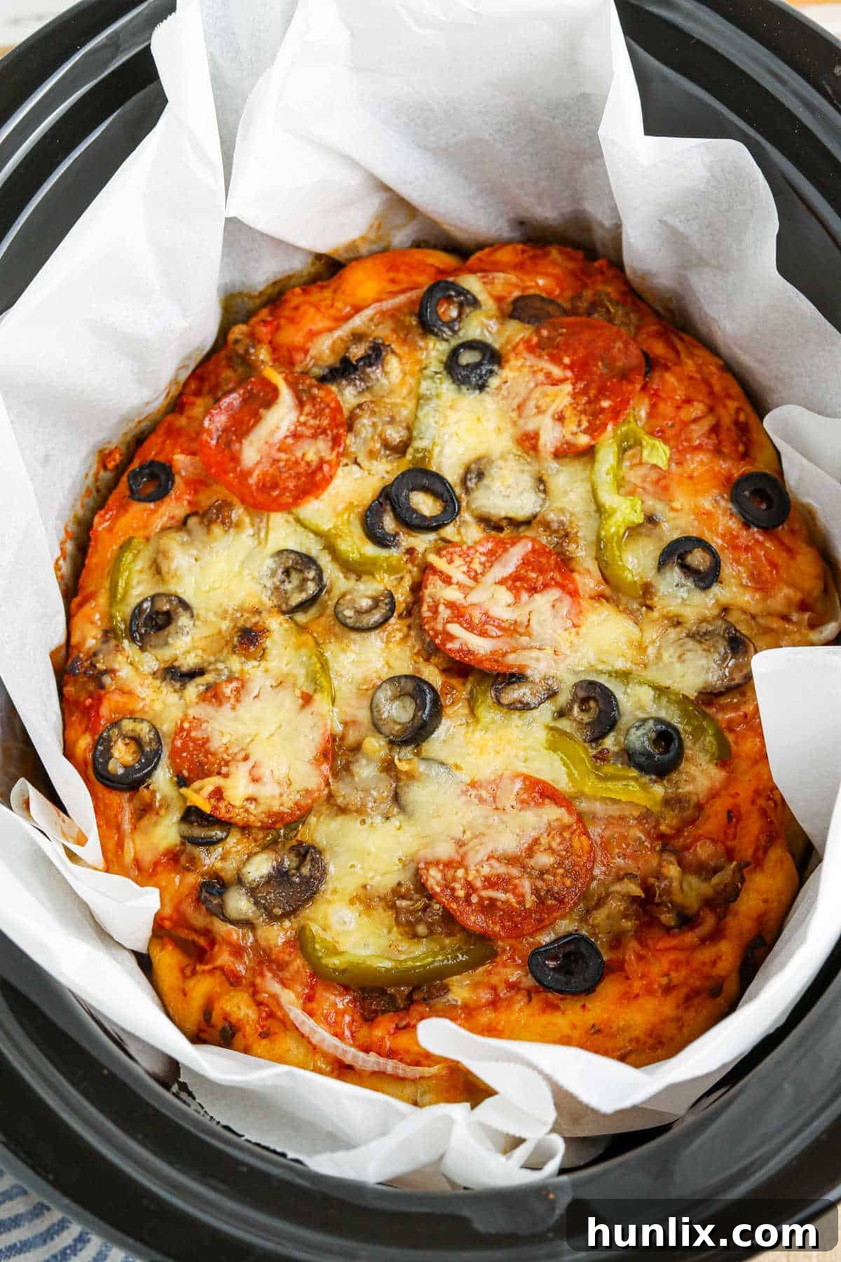 A delicious supreme pizza cooking to perfection in a Crockpot.