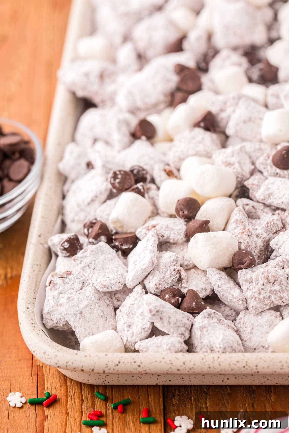 Hot chocolate muddy buddies on a baking sheet.