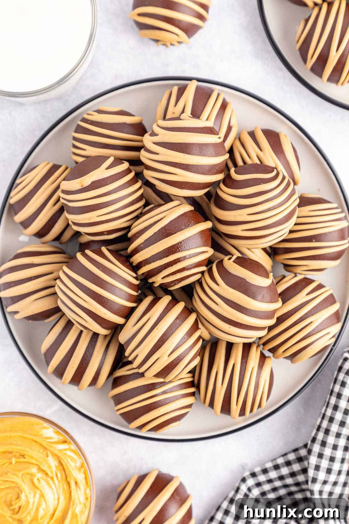 Choco-Peanut Butter Bliss Balls 2 Chocolate covered peanut butter balls on a plate.