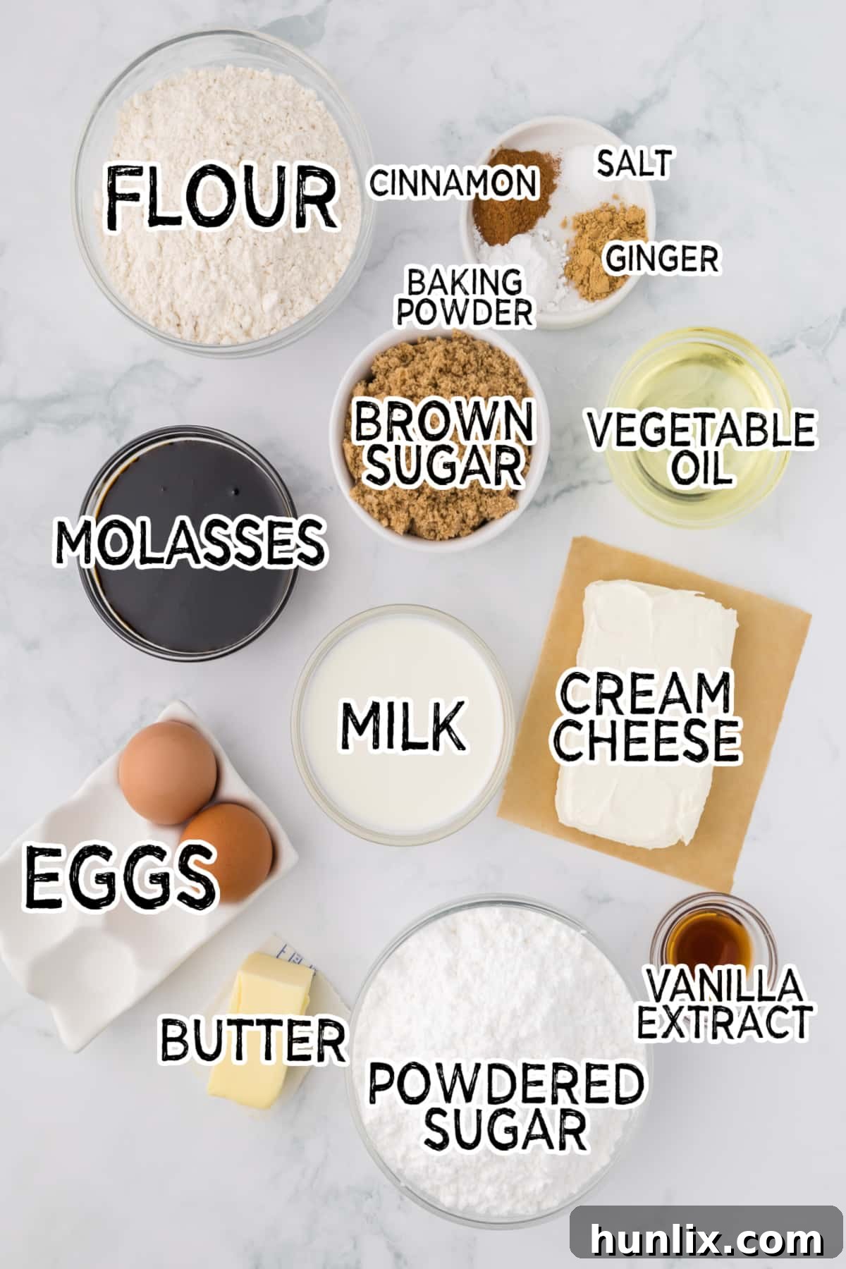 Molasses Ginger Cupcake Bliss 3 A beautiful array of gingerbread cupcake ingredients laid out on a white marble background.