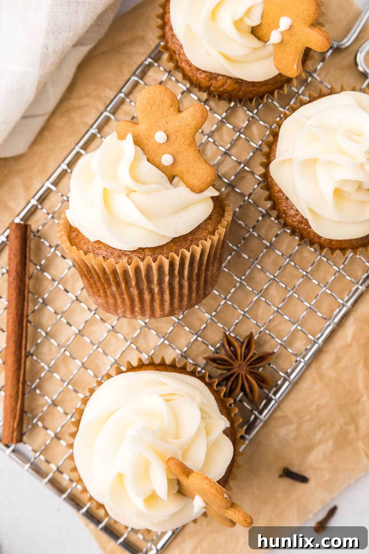 Molasses Ginger Cupcake Bliss 7 Delicious gingerbread cupcakes frosted and displayed on a wire rack.