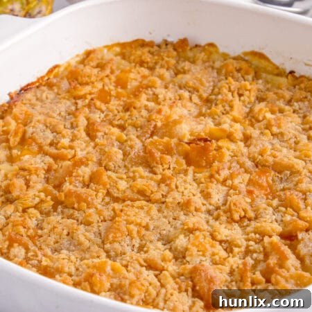 Delicious Southern Pineapple Casserole with a perfectly golden and crispy topping, served in a white baking dish.