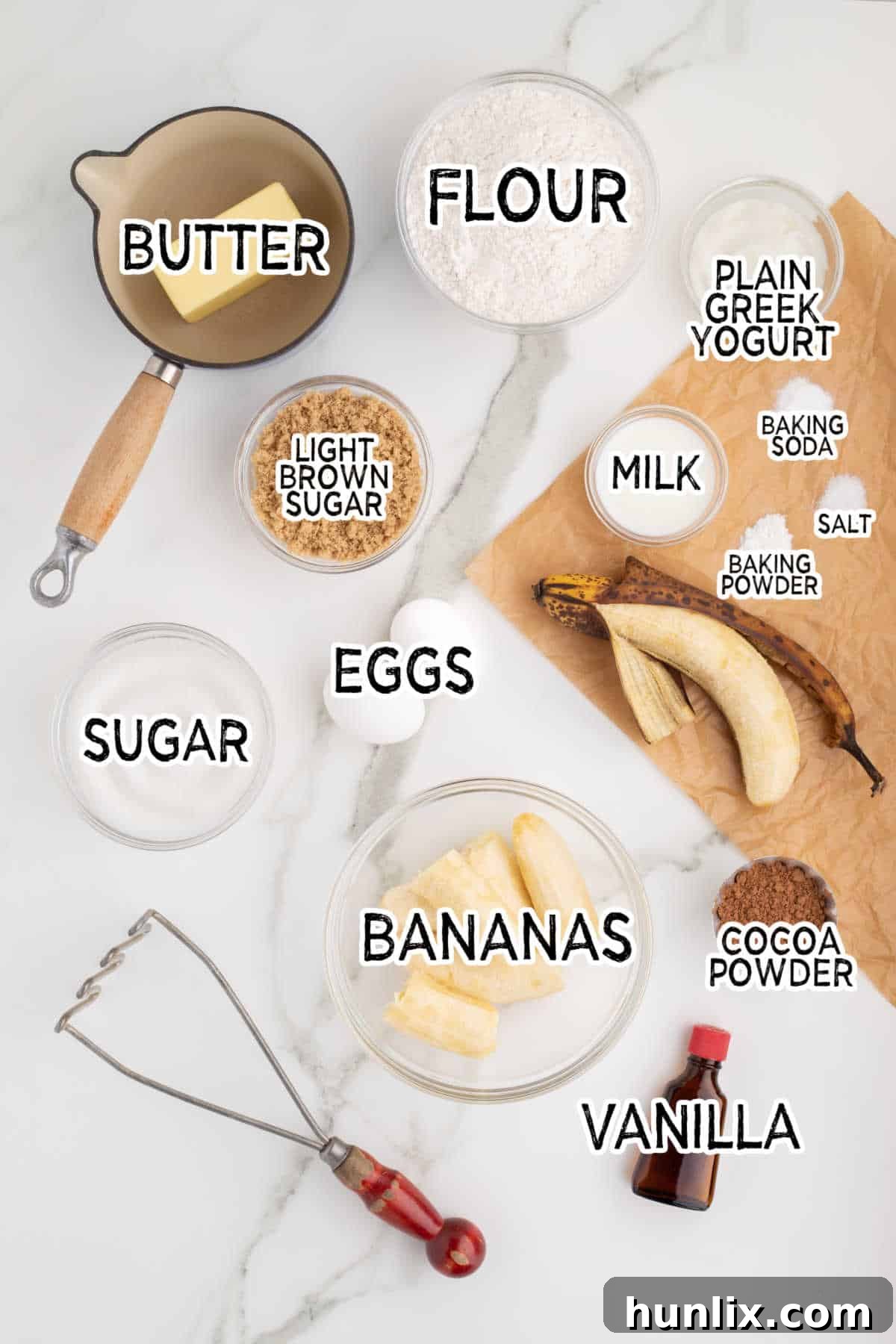 All the ingredients for making marbled banana bread laid out on a surface.