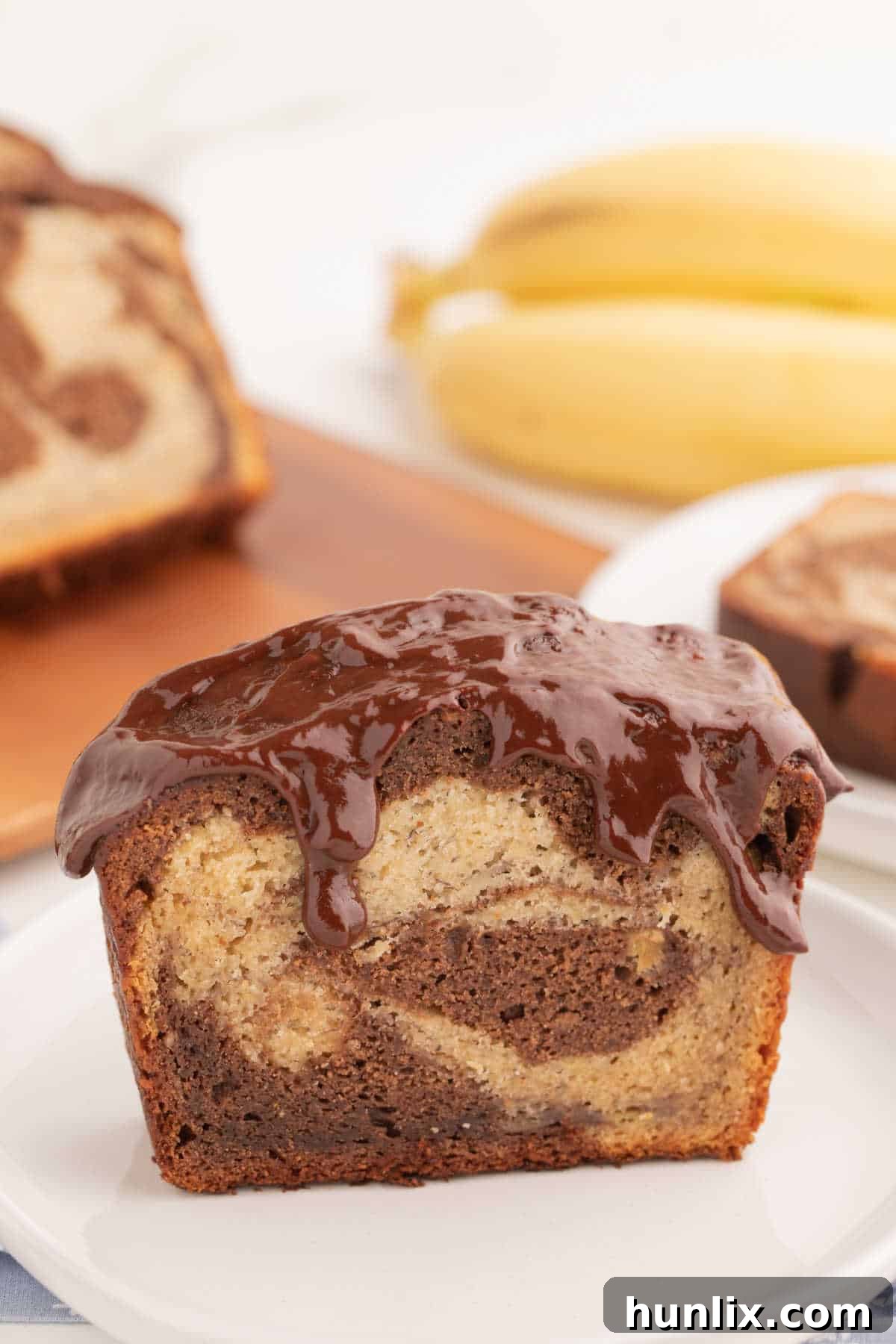 A perfectly sliced piece of marbled banana bread on a plate, ready to be enjoyed.