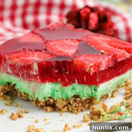 A close-up of a beautifully set Christmas Pretzel Salad, sliced and ready to serve.