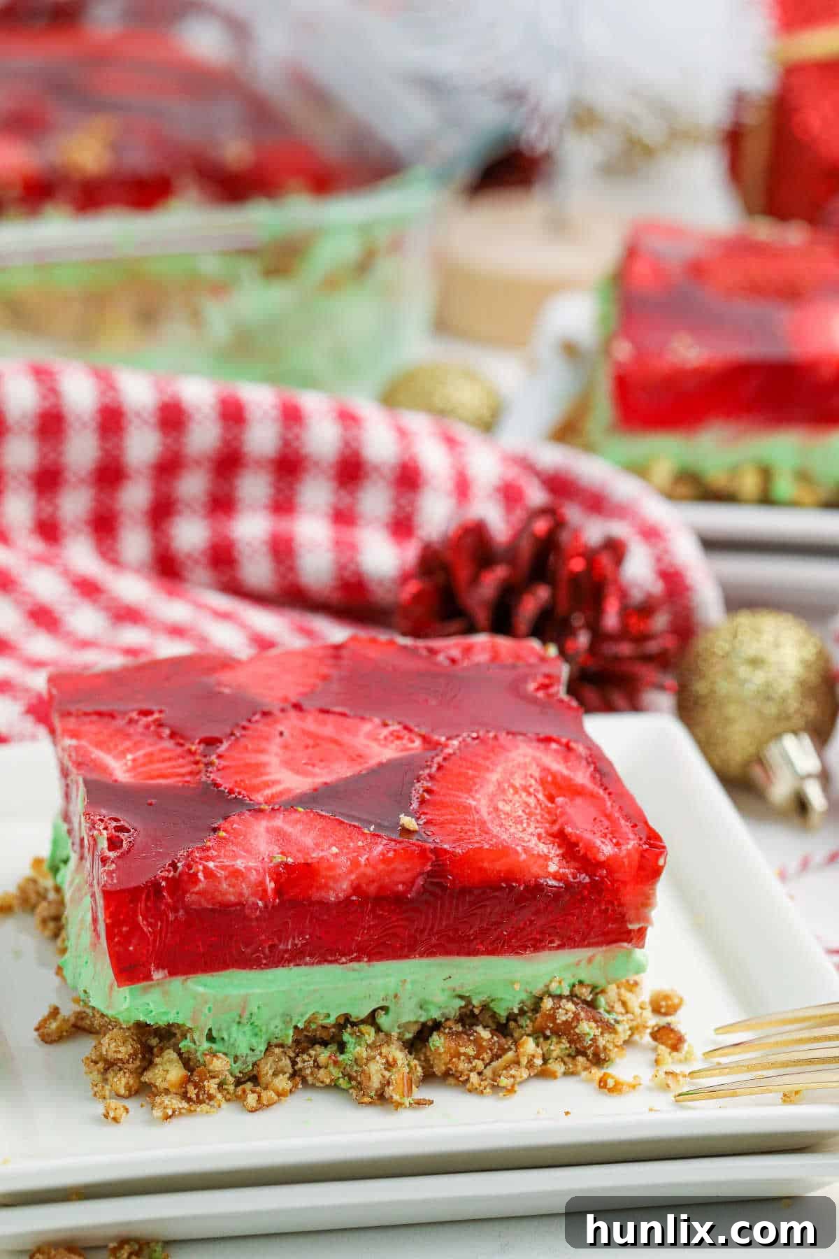 Sweet & Salty Christmas Pretzel Delight 7 A vibrant slice of Christmas Pretzel Salad on a white plate, ready to be enjoyed.