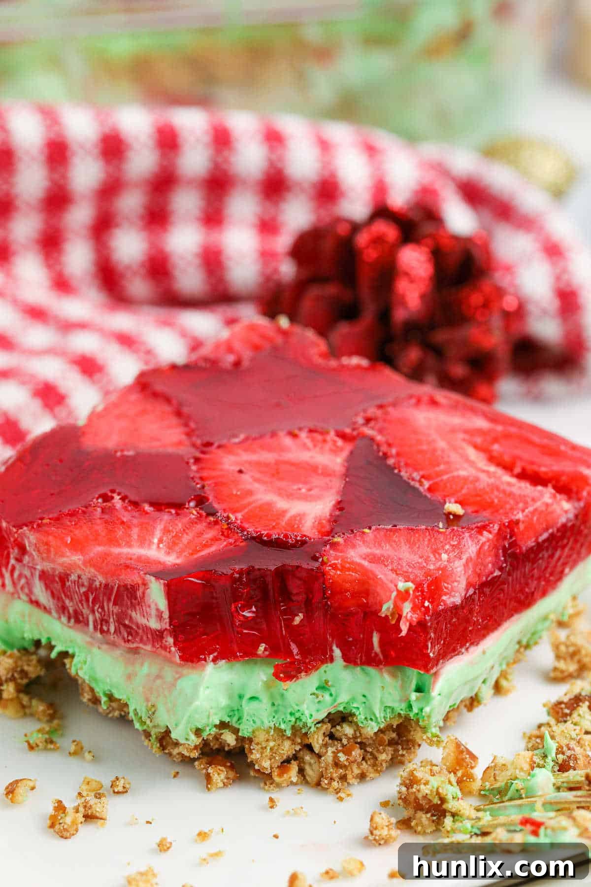 Sweet & Salty Christmas Pretzel Delight 10 A slice of Christmas Pretzel Salad on a plate with a bite taken out, showing the perfect layers and inviting texture.