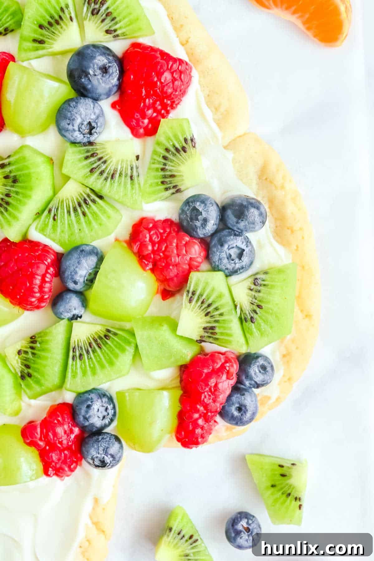 A vibrant sugar cookie Christmas tree against a white background, perfect for holiday gatherings.