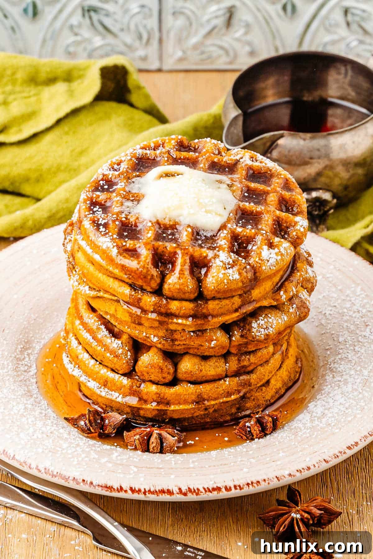 A plate of perfectly cooked golden-brown gingerbread waffles, ready to be topped.