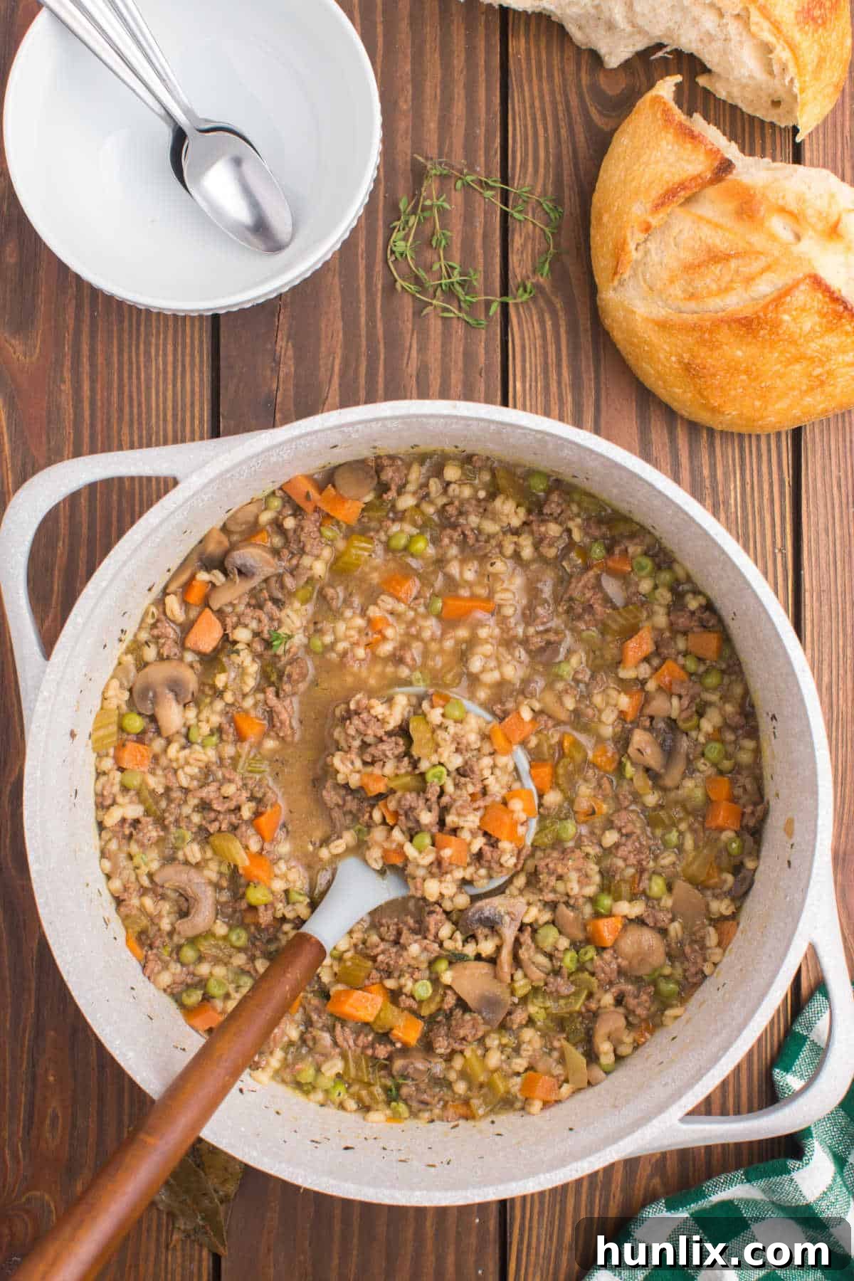 Hearty Beef and Barley Comfort Soup 2 A pot of beef and barley soup with a ladle in it.