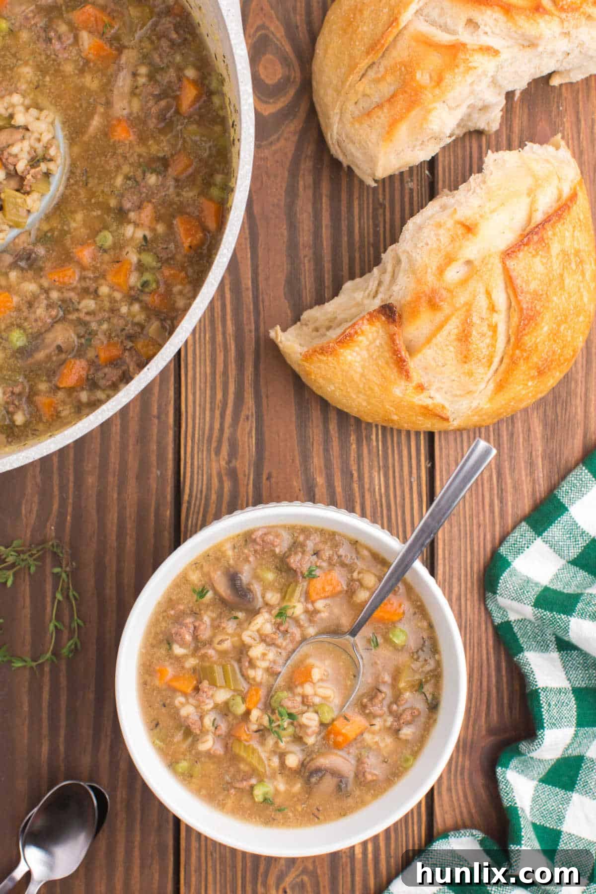 Hearty Beef and Barley Comfort Soup 7 A bowl of beef and barley soup with a spoon.