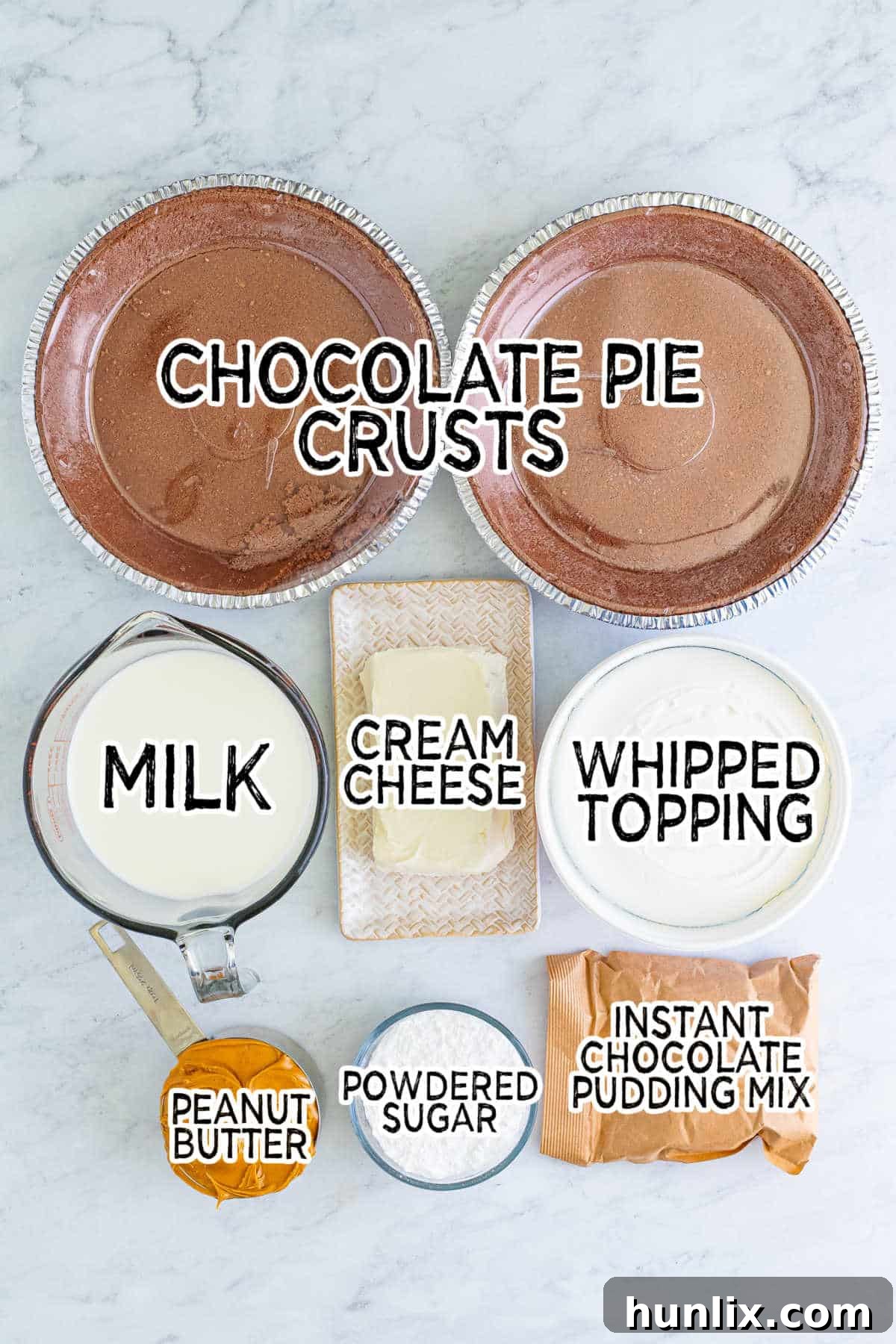 Heavenly Chocolate Peanut Butter Indulgence 3 A collection of ingredients laid out on a table, including instant chocolate pudding mix, milk, cream cheese, peanut butter, powdered sugar, whipped topping, and two chocolate pie crusts.