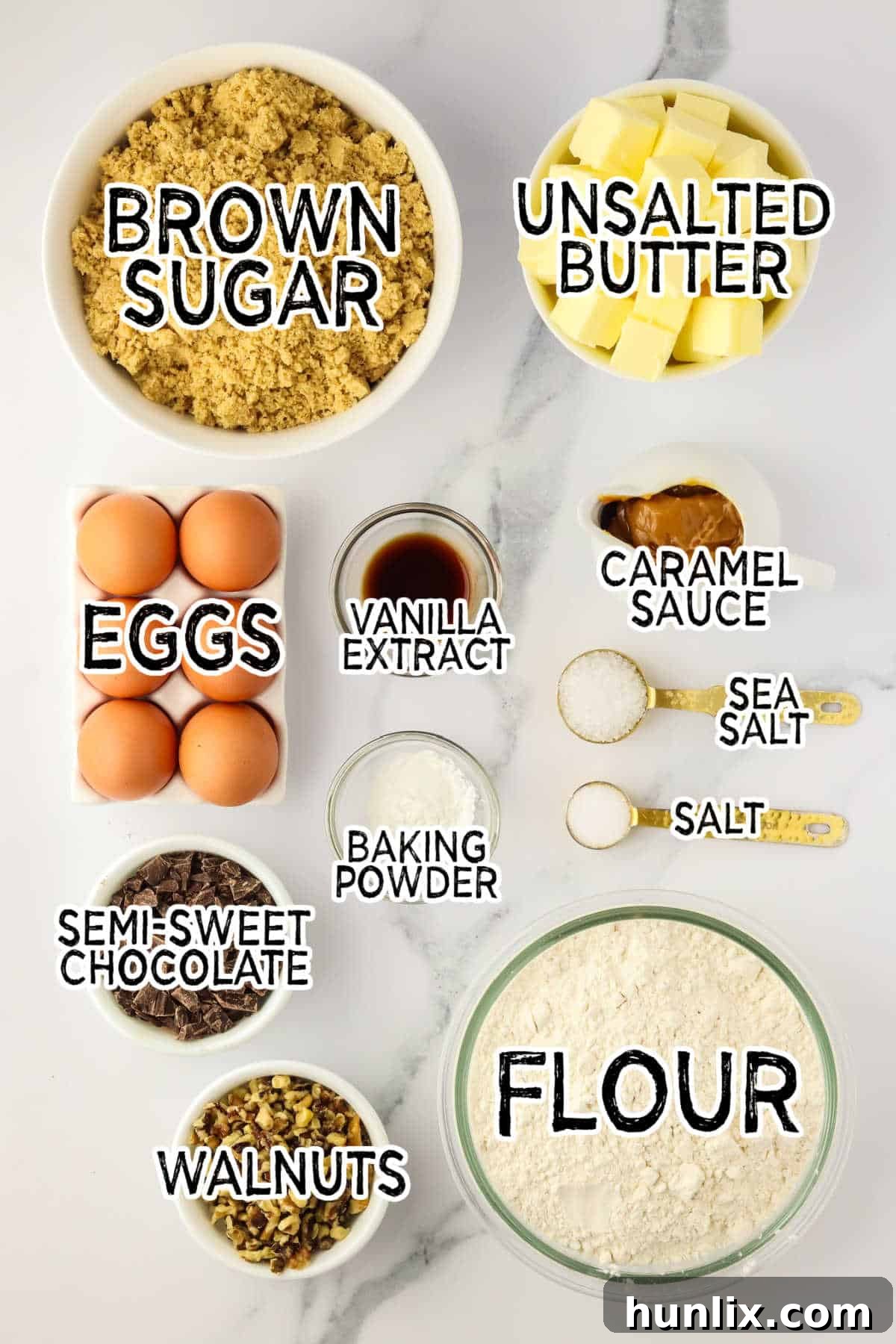 A beautiful flat lay of all the brown butter caramel blondies ingredients on a white marble surface, ready for baking.
