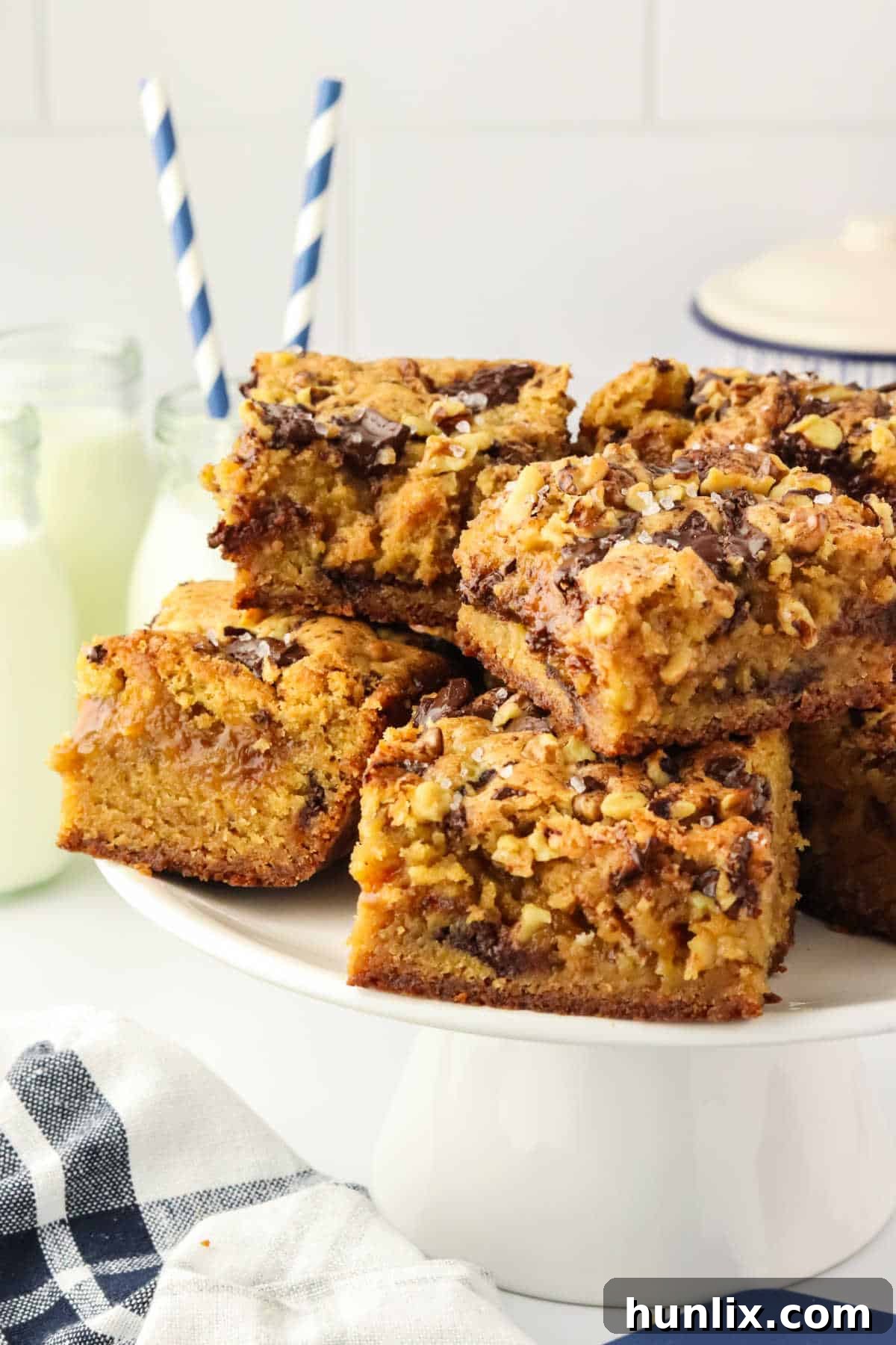 The finished brown butter caramel blondies displayed beautifully on a cake stand, ready to be served.