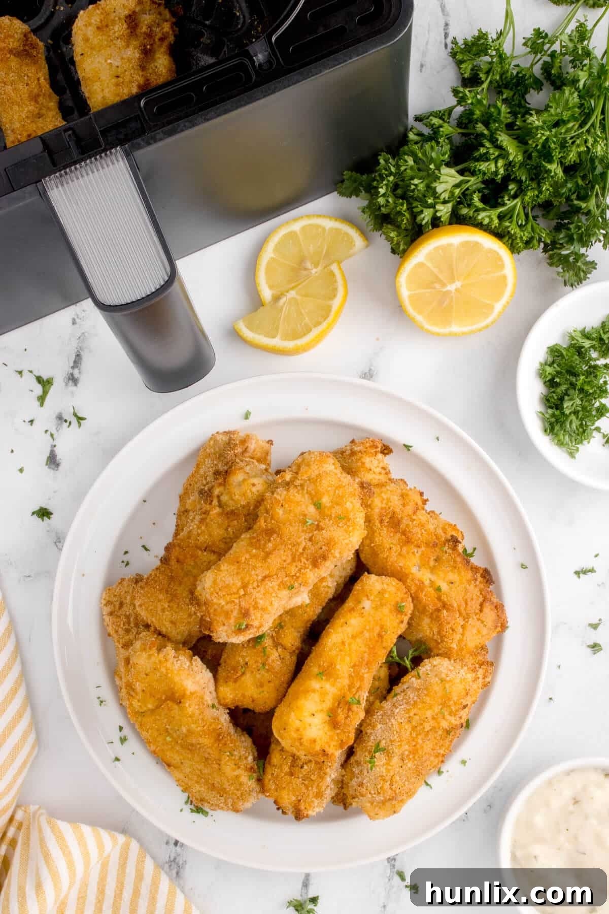 The air-fried fish sticks arranged appetizingly on a plate.
