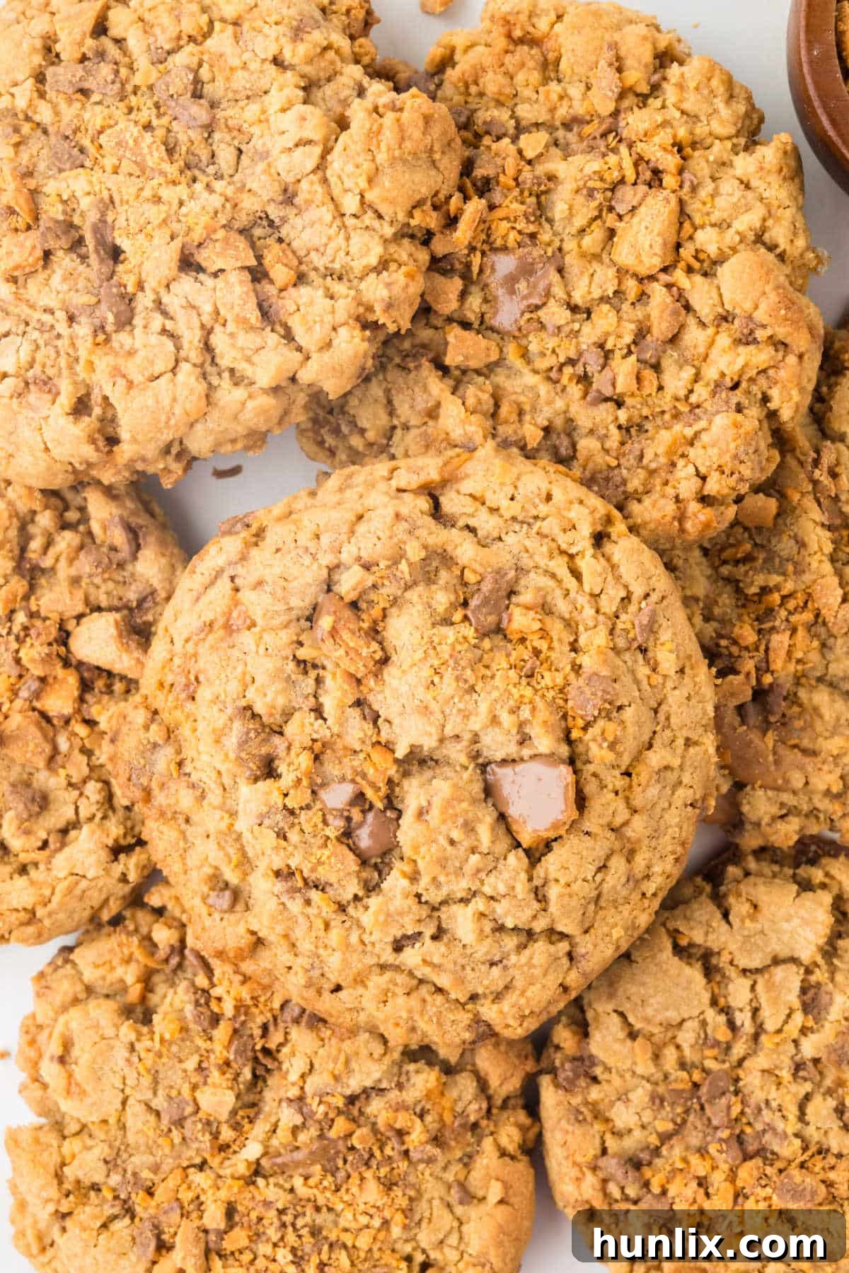A group of freshly baked Butterfinger Cookies with visible candy pieces.