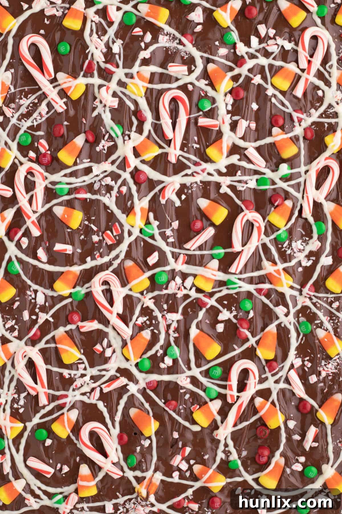 Buddy the Elf's Irresistible Christmas Crack 2 Buddy the Elf Christmas Crack on a baking sheet, showcasing festive toppings.