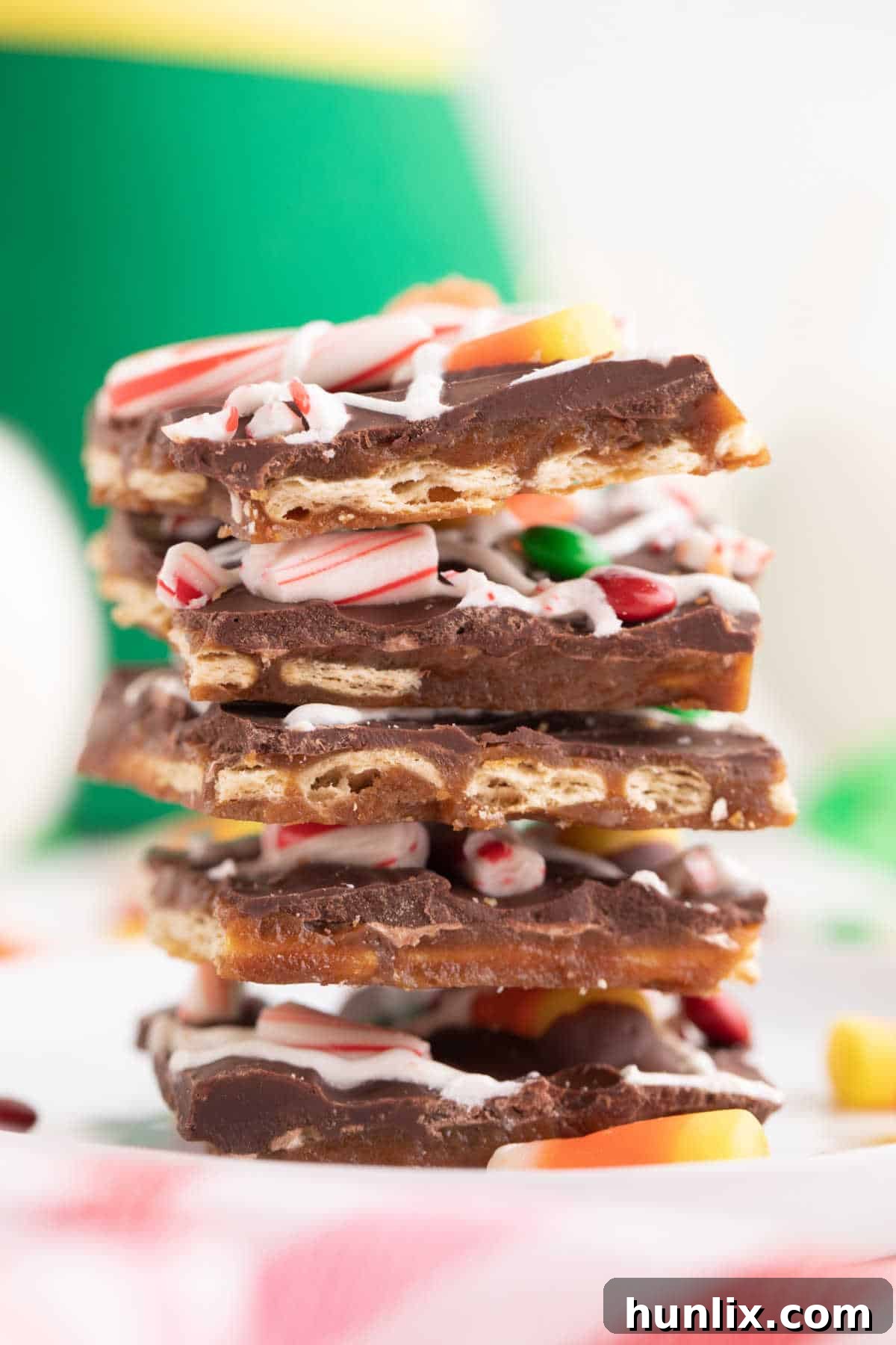 Buddy the Elf's Irresistible Christmas Crack 8 A stack of individual Buddy the Elf Christmas Crack pieces, showing the layers of cracker, caramel, chocolate, and various candies.