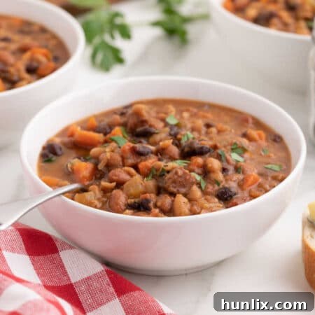 Final bowl of Crockpot Ham and Bean Soup with a spoon.
