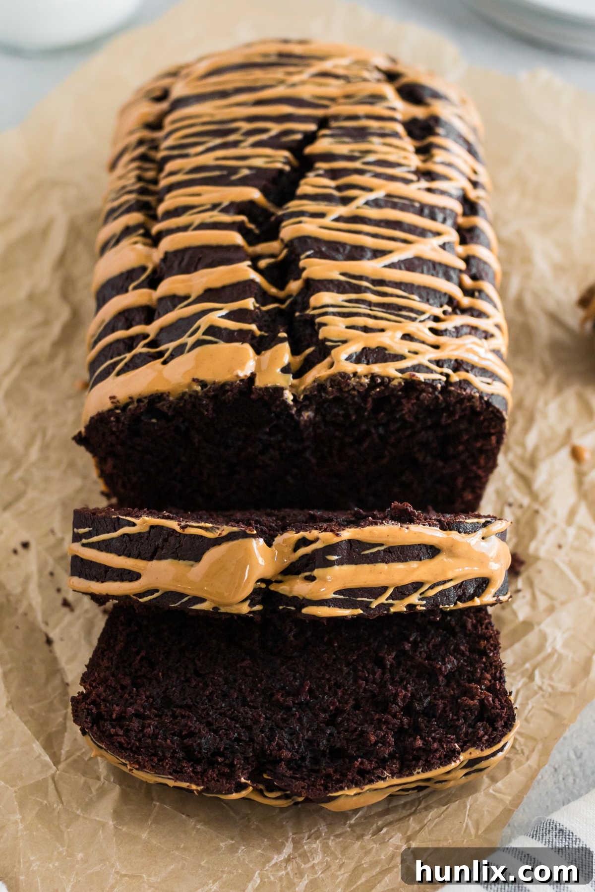A loaf of chocolate peanut butter banana bread with slices cut.